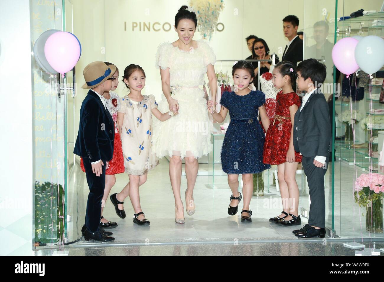 Chinese actress Zhang Ziyi, center, arrives with young kids at the opening ceremony for the new store of Italian luxury children's wear brand I PINCO Stock Photo