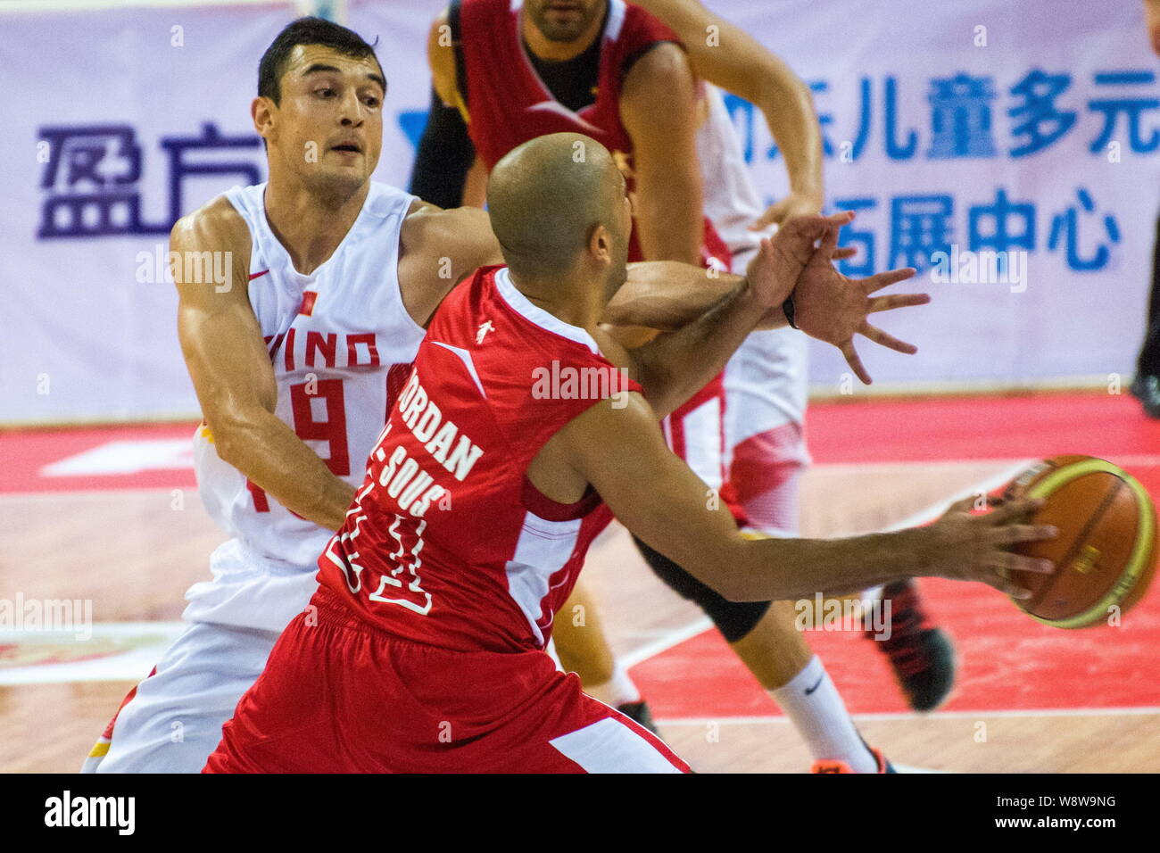 Shirelijan Muxtar of Chinese men's national basketball team, left, competes in the China-Jordan friendly match against Jordan in Shenzhen city, south Stock Photo
