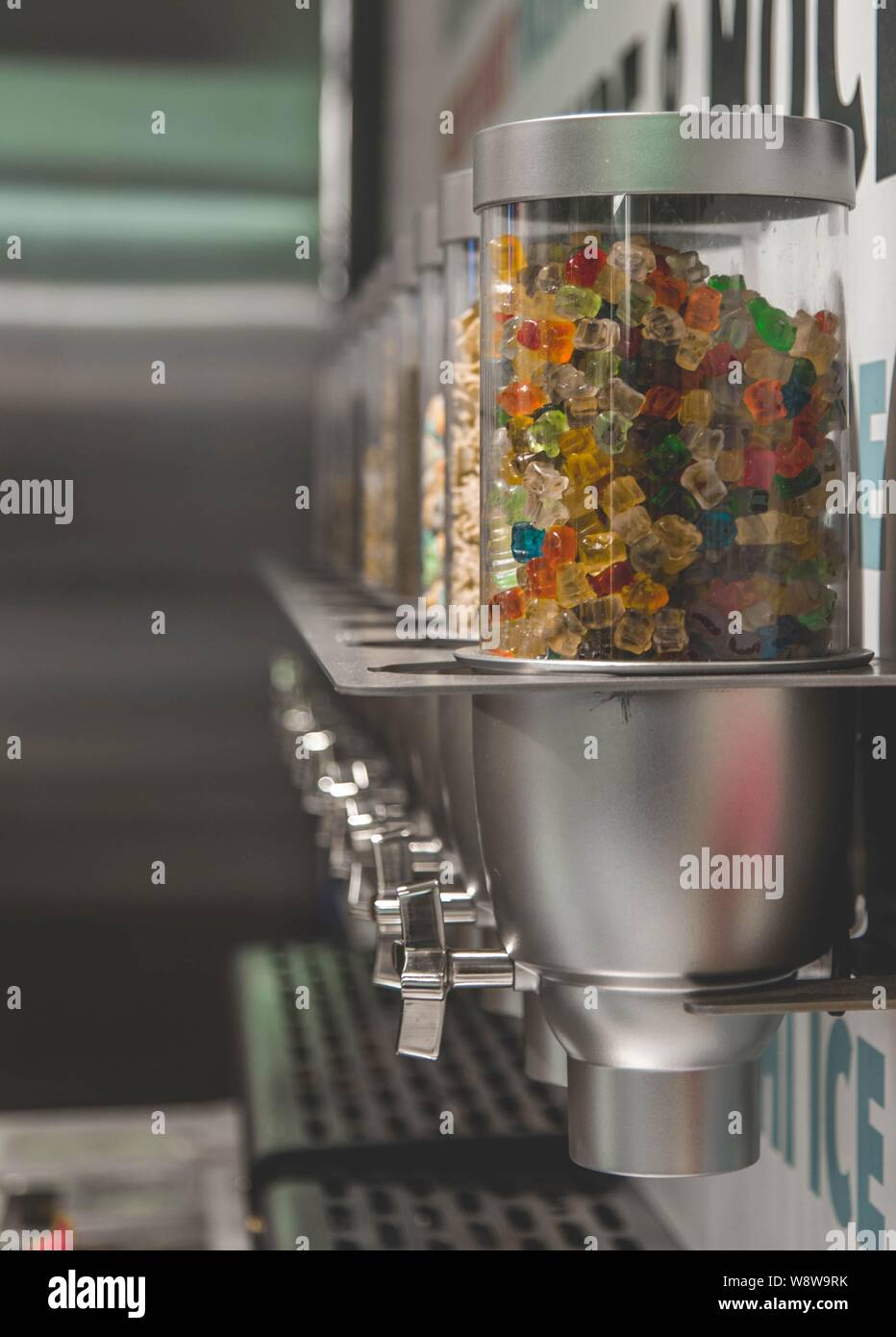 Vertical shot of colorful gummy candies inside of a dispenser Stock