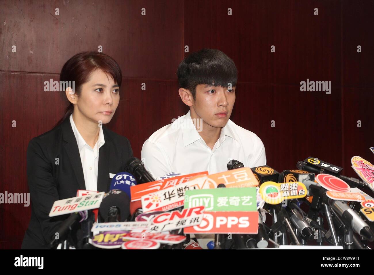 Taiwanese actor Kai Ko, right, sits next to his manager Angie Chai, during the press conference to apologize again for taking drugs, after being relea Stock Photo