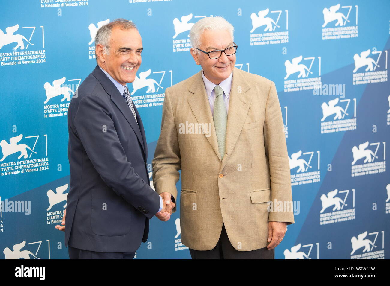 Italian actor and director Alberto Barbera, left, shakes hands with Festival President Paolo Baratta at the Jury photocall during the 71st Venice Film Stock Photo