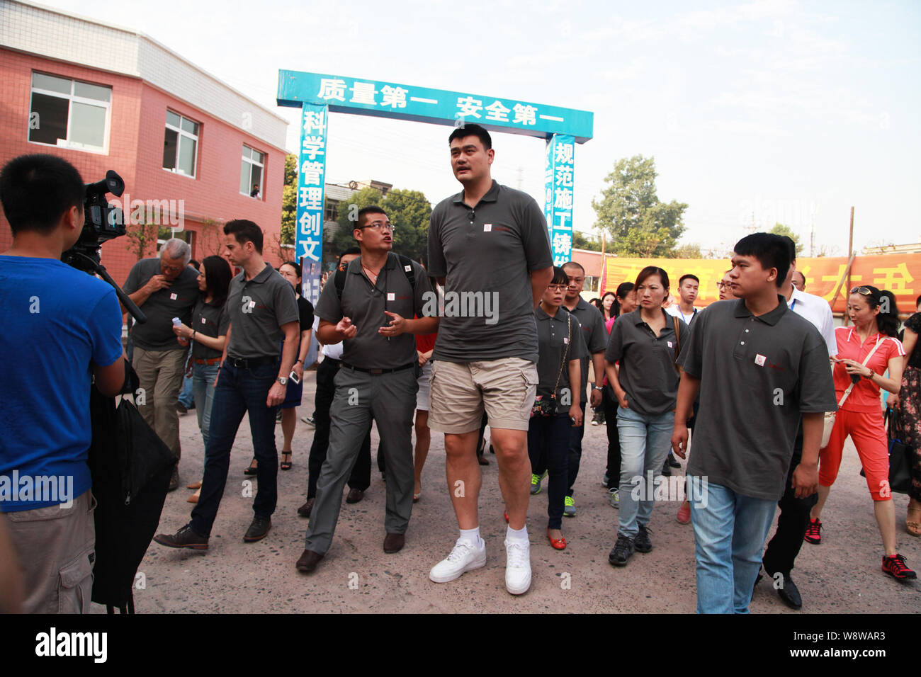 Retired Chinese basketball superstar Yao Ming, tallest, is pictured as he arrives at a primary school to promote Yao Foundation Hope Project in Shidon Stock Photo