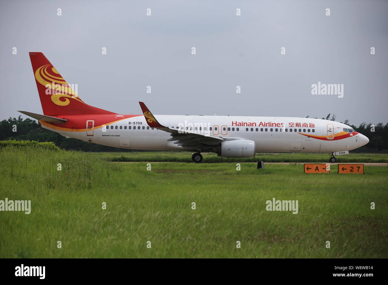 --FILE--A plane of Hainan Airlines is pictured at the Haikou Meilan International Airport in Haikou city, south Chinas Hainan province, 12 June 2014. Stock Photo