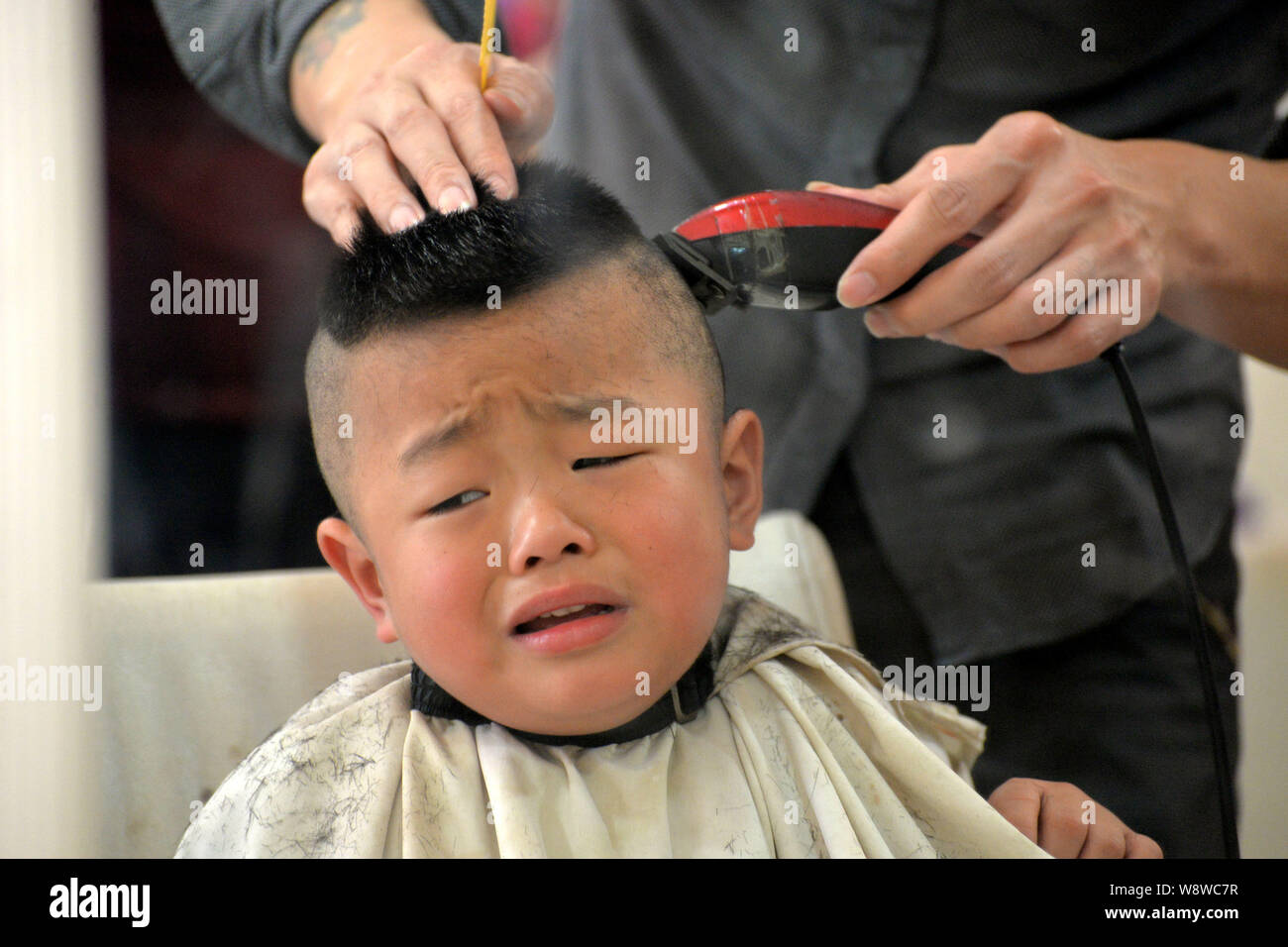 A Chinese kid has his hair cut at the barbers on Dragon Heads-raising Day  in Handan city, north Chinas Hebei province, 2 March 2014. Chinese kids ha  Stock Photo - Alamy
