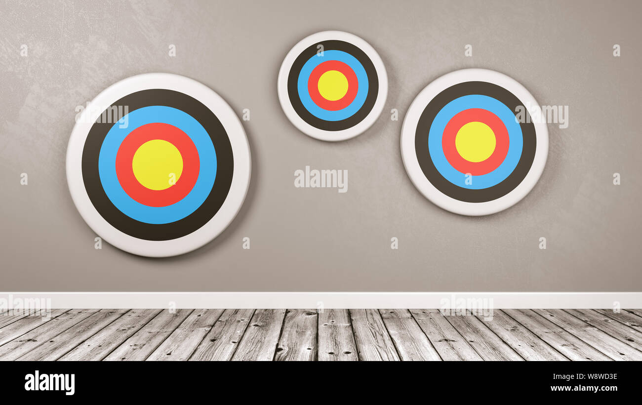 Three Different Size Colorful Arrow Targets Against a Gray Wall with Copy Space 3D Illustration Stock Photo