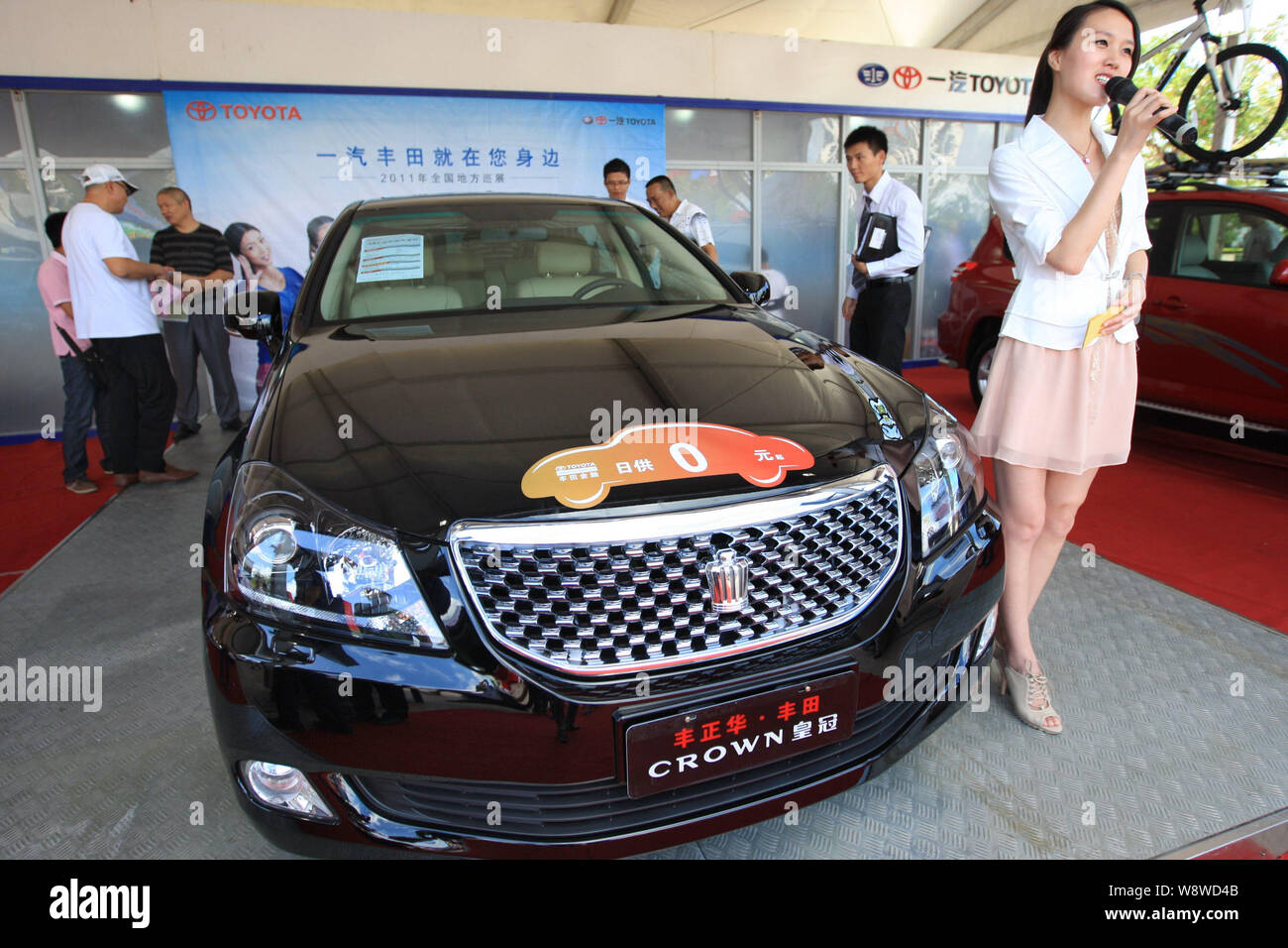 --FILE--Visitors look at a Toyota Crown of FAW-Toyota, a joint venture ...