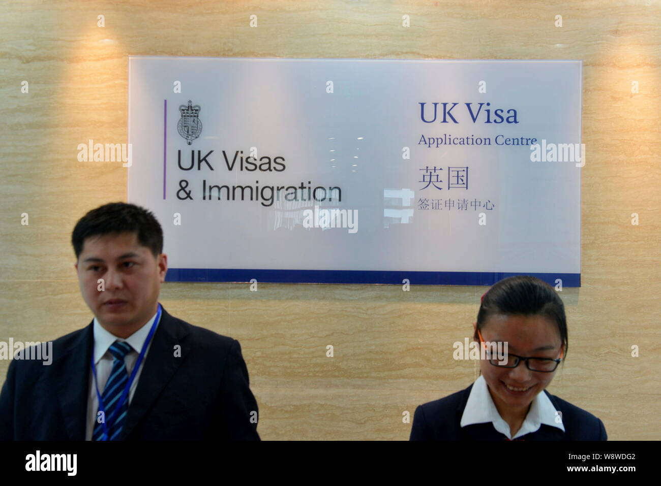 --FILE--Chinese employees are seen at the UK Visa Application Centre in Chengdu city, southwest Chinas Sichuan province, 5 May 2014.   Britain will fu Stock Photo