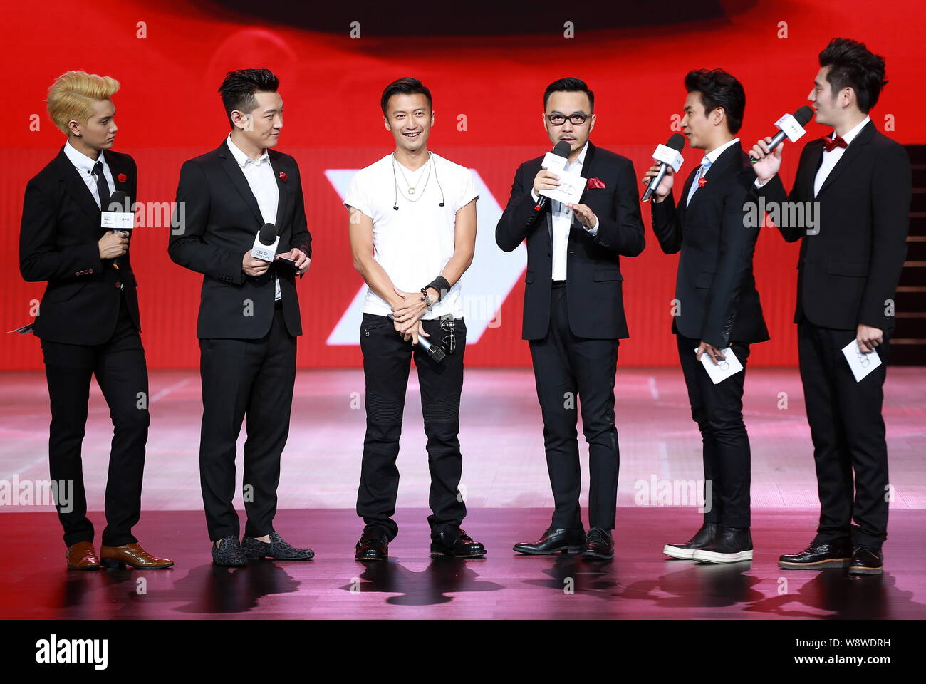 Hong Kong singer and actor Nicholas Tse, third left, poses at a launch ...