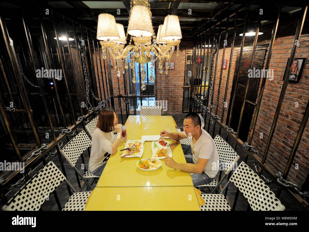Customers dine in an eating room at the first prison-themed restaurant in Tianjin, China, 6 September 2014.   A special restaurant modeled on prison c Stock Photo