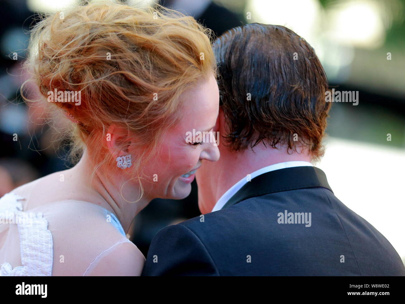 American actress Uma Thurman, left, whispers to director Quentin Tarantino as they arrive at the red carpet for the closing ceremony of the 67th Canne Stock Photo