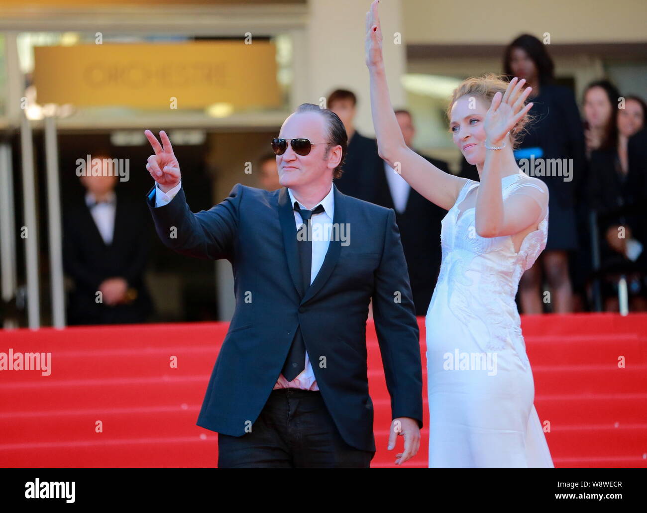 American actress Uma Thurman, right, and director Quentin Tarantino wave as they arrive at the red carpet for the closing ceremony of the 67th Cannes Stock Photo