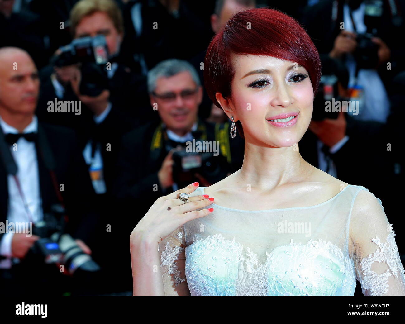 Chinese actress Jin Qiaoqiao poses as she arrives at the opening red carpet event of the 67th Cannes Film Festival in Cannes, France, 14 May 2014. Stock Photo