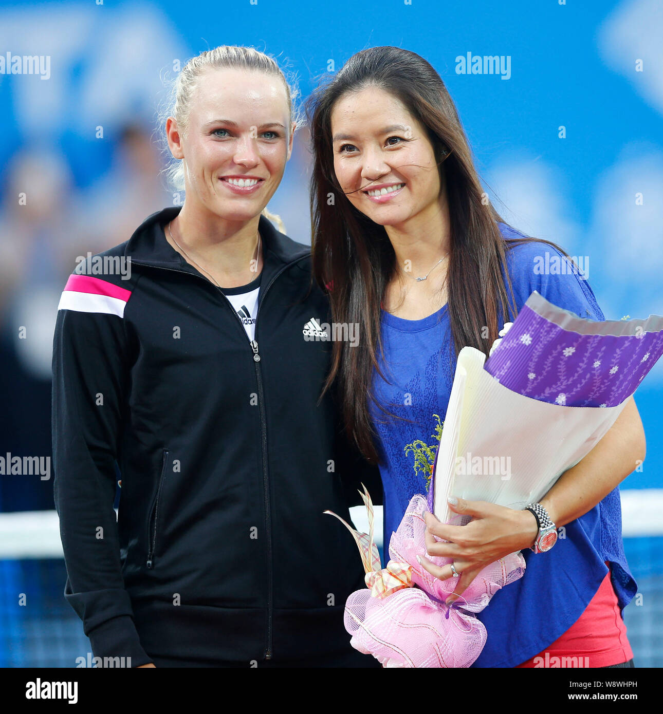 Chinese tennis star Li Na, right, poses with Danish tennis player Caroline Wozniacki during a brief retirement ceremony during the 2014 WTA Wuhan Open Stock Photo