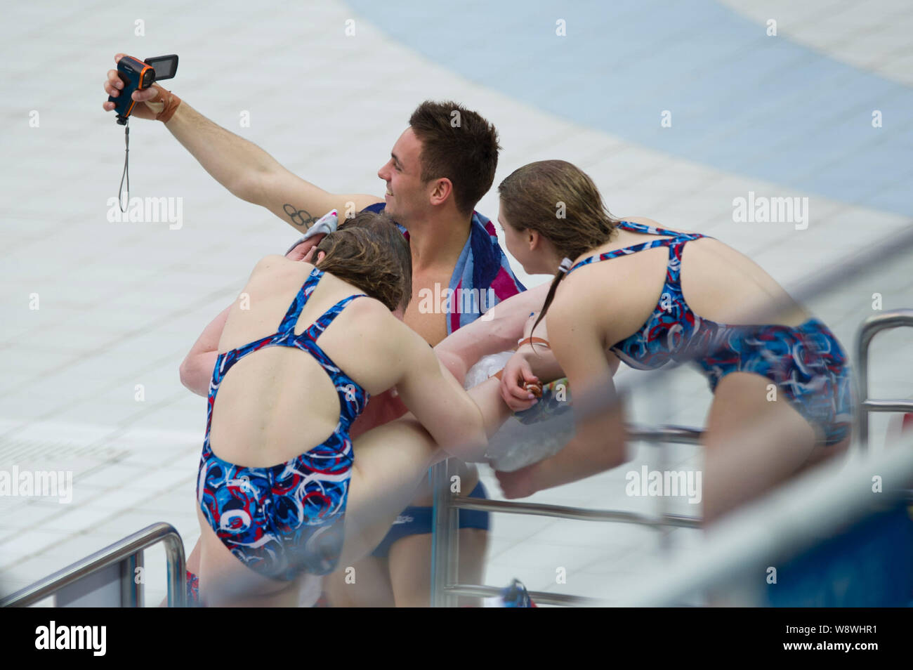 English diver Tomas Daley, back, takes selfies with female teammates during a training session of the FINA/NVC Diving World Series 2014 at the Nationa Stock Photo