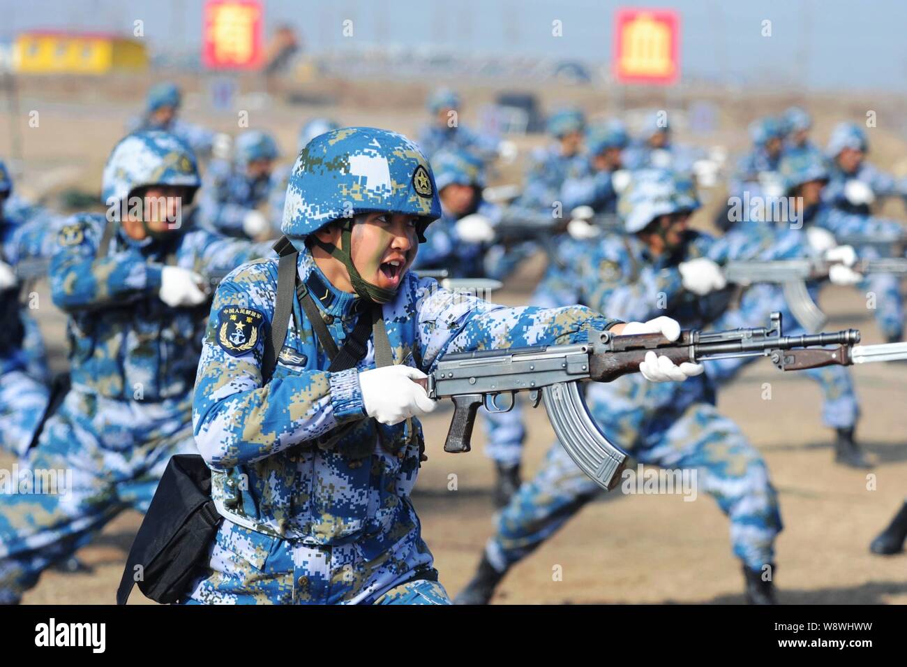 Female Chinese soldiers practice with guns during a training session in