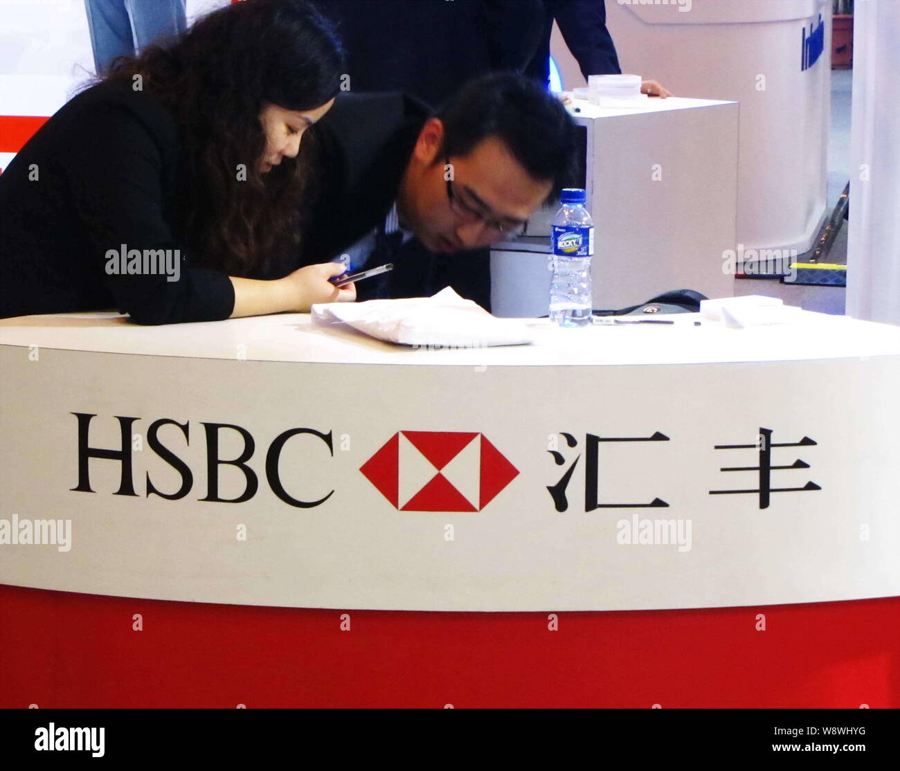 File Employees Are Seen At The Stand Of Hsbc During An Exhibition