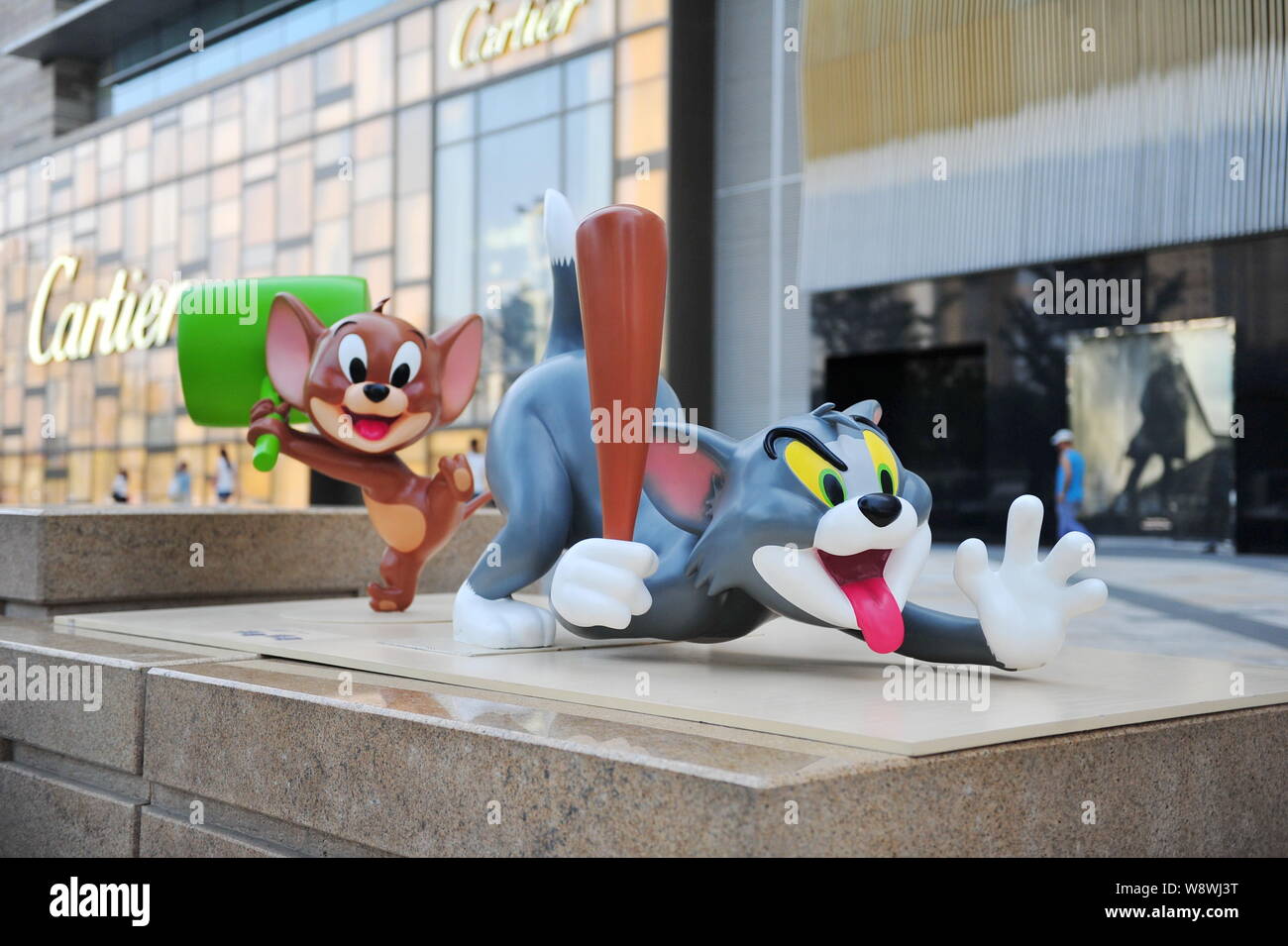 Sculptures of cartoon figures Tom and Jerry are on display in front of the fashion boutique of Cartier at The Mixc shopping mall in Shenyang city, nor Stock Photo
