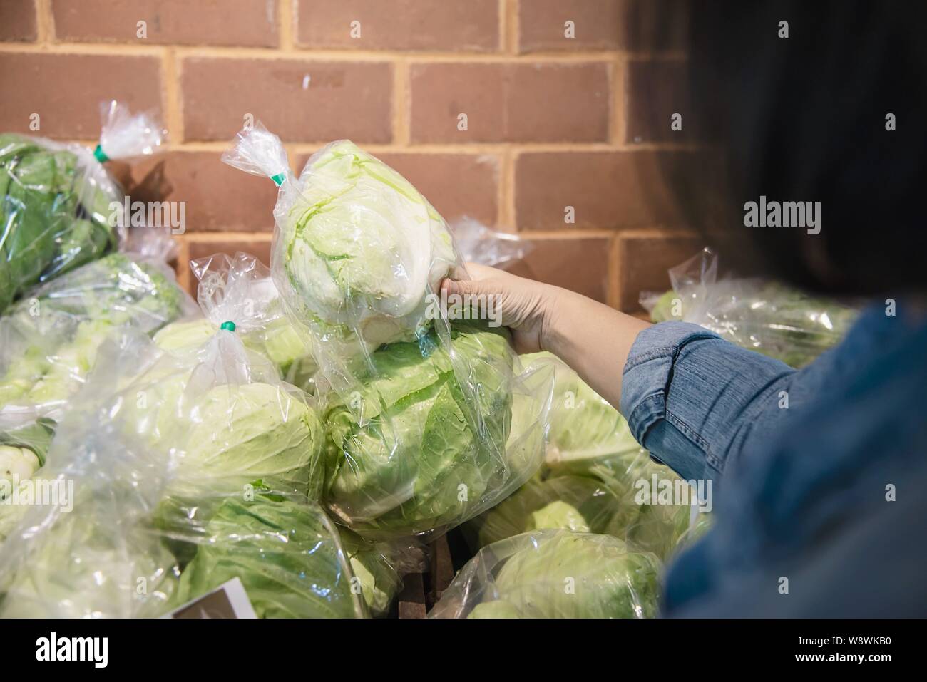 Lady is shopping fresh vegetable in supermarket store - woman in fresh market lifestyle concept Stock Photo