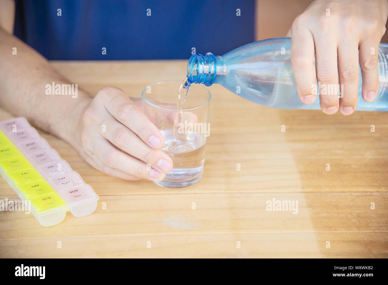 Man is going to eat medicine tablet - people with medical health problem concept Stock Photo