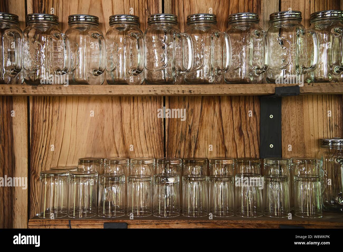 Glass ware in coffee shop with brown wooden wall - vintage style coffee shop decoration concept Stock Photo