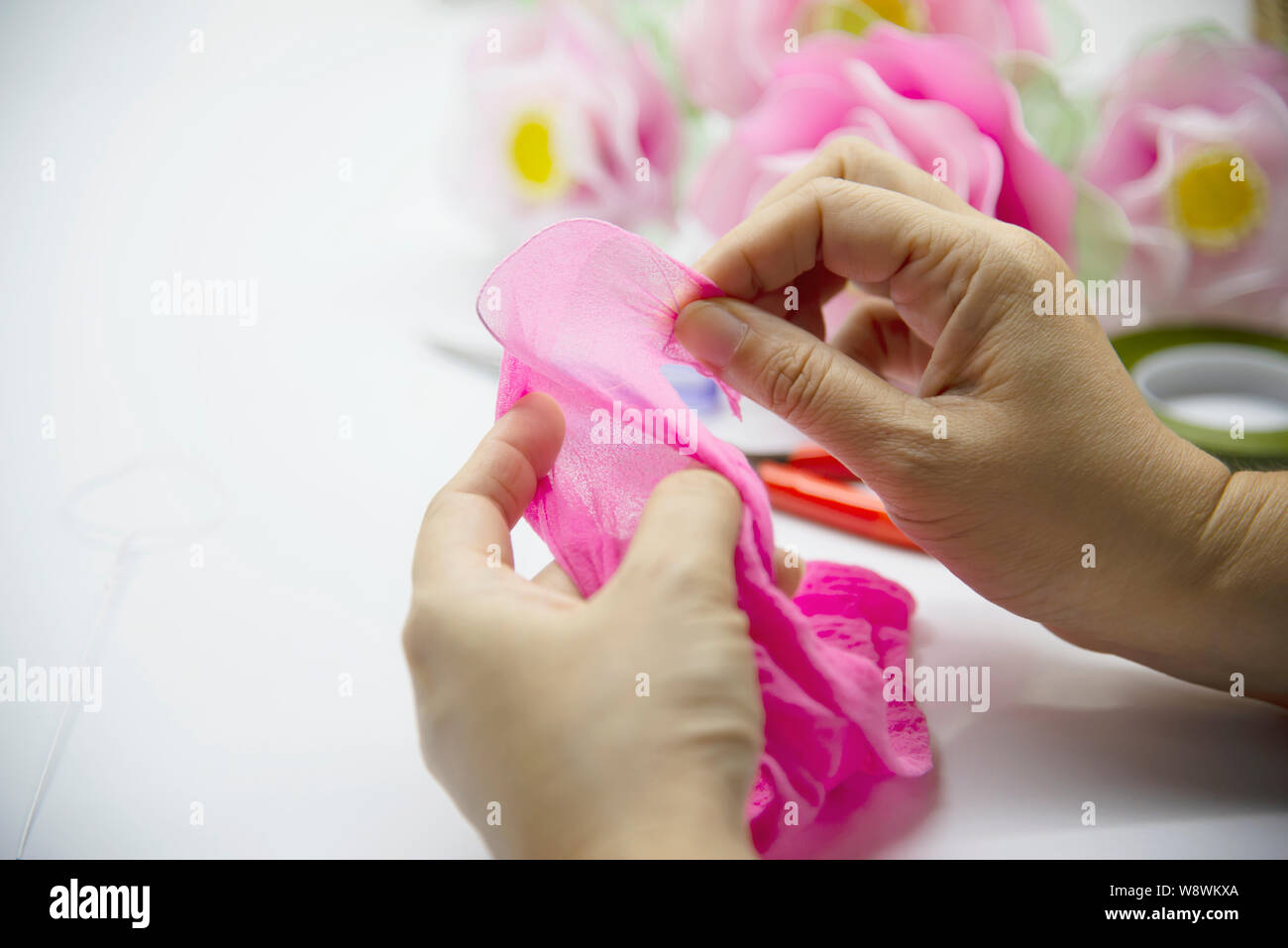 Woman making beautiful nylon flower - people with DIY handmade flower concept Stock Photo