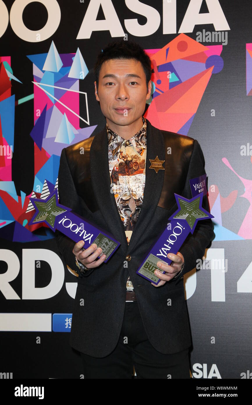 Hong Kong singer Andy Hui poses with his trophies after the