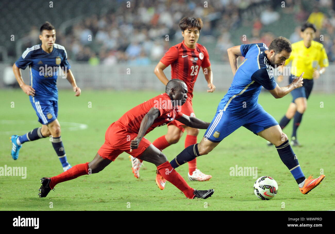 Wisdom Fofo Agbo of Hong Kong, front left, challenges Gonzalo Higuain of Argentina, right, during a friendly football match in Hong Kong, China, 14 Oc Stock Photo