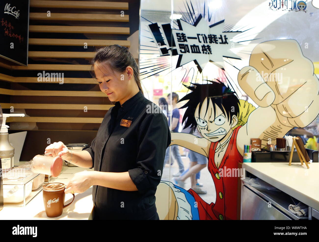 An Employee Prepares A Coffee For A Customer At The One Piece Themed Mcdonalds Fastfood Restaurant In Guangzhou City South Chinas Guangdong Province Stock Photo Alamy