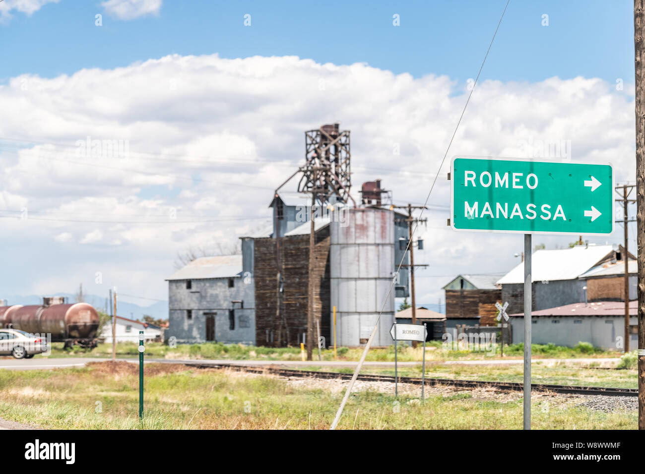 Romeo, USA - June 20, 2019: Highway 285 in Colorado with old vintage town industrial building and sign for Romeo and Manassa Stock Photo