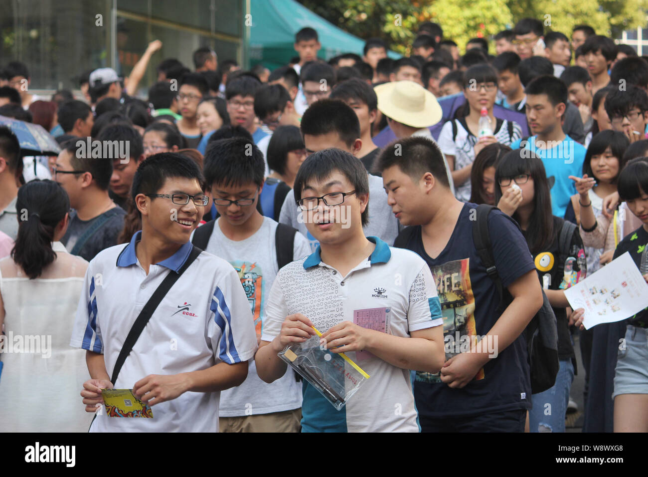 Students leave the campus after finishing the National College Entrance Exam (Gaokao) at a high school in Shiyan city, central Chinas Hubei province, Stock Photo