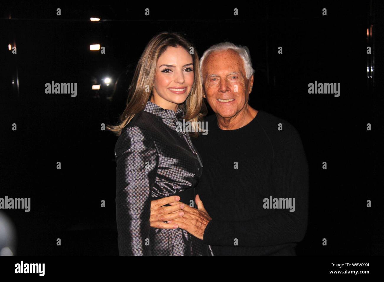 Fashion designer Giorgio Armani, right, poses with a guest after the Emporio  Armani 2014 Fall/Winter fashion show during the Milan Fashion Week in Mil  Stock Photo - Alamy