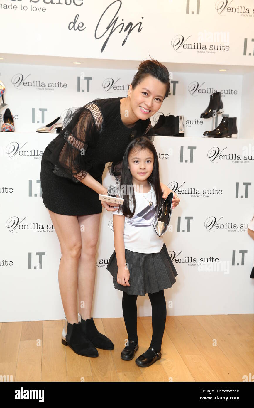 Hong Kong singer and actress Gigi Leung who is five months pregnant poses with a young girl at a launch event for Venilla Suite shoes in Hong Kong, Ch Stock Photo