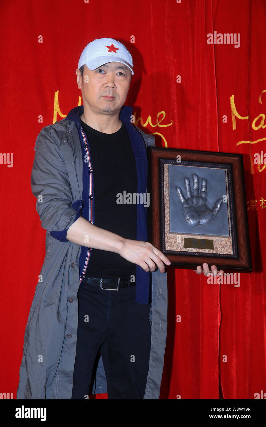 Chinese singer-songwriter Cui Jian poses with his handprint during an
