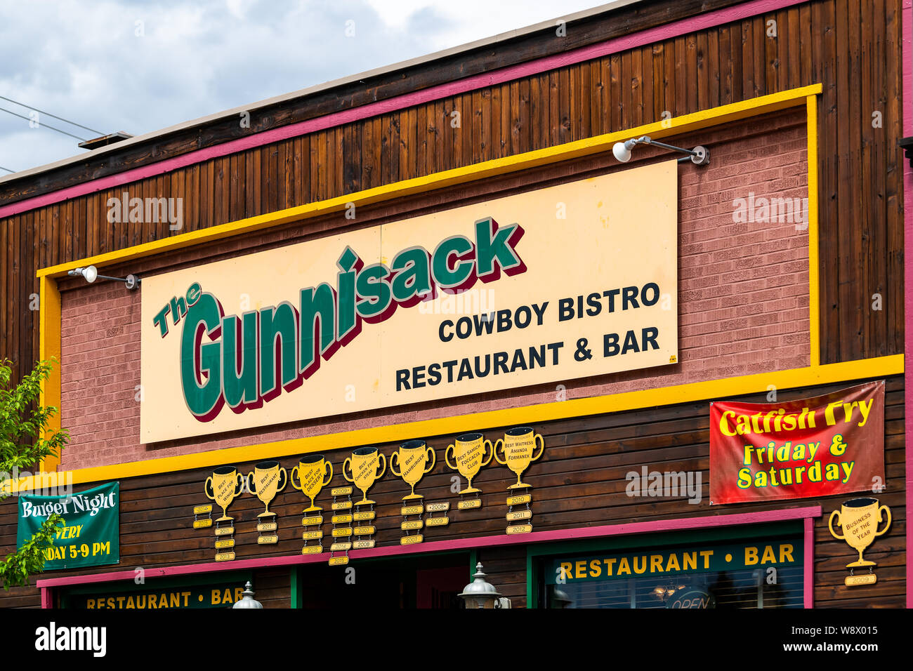 Gunnison, USA - June 20, 2019: Colorado city downtown stores shops restaurants on Main street with sign for Gunnisack Cowboy Bistro and Bar Stock Photo