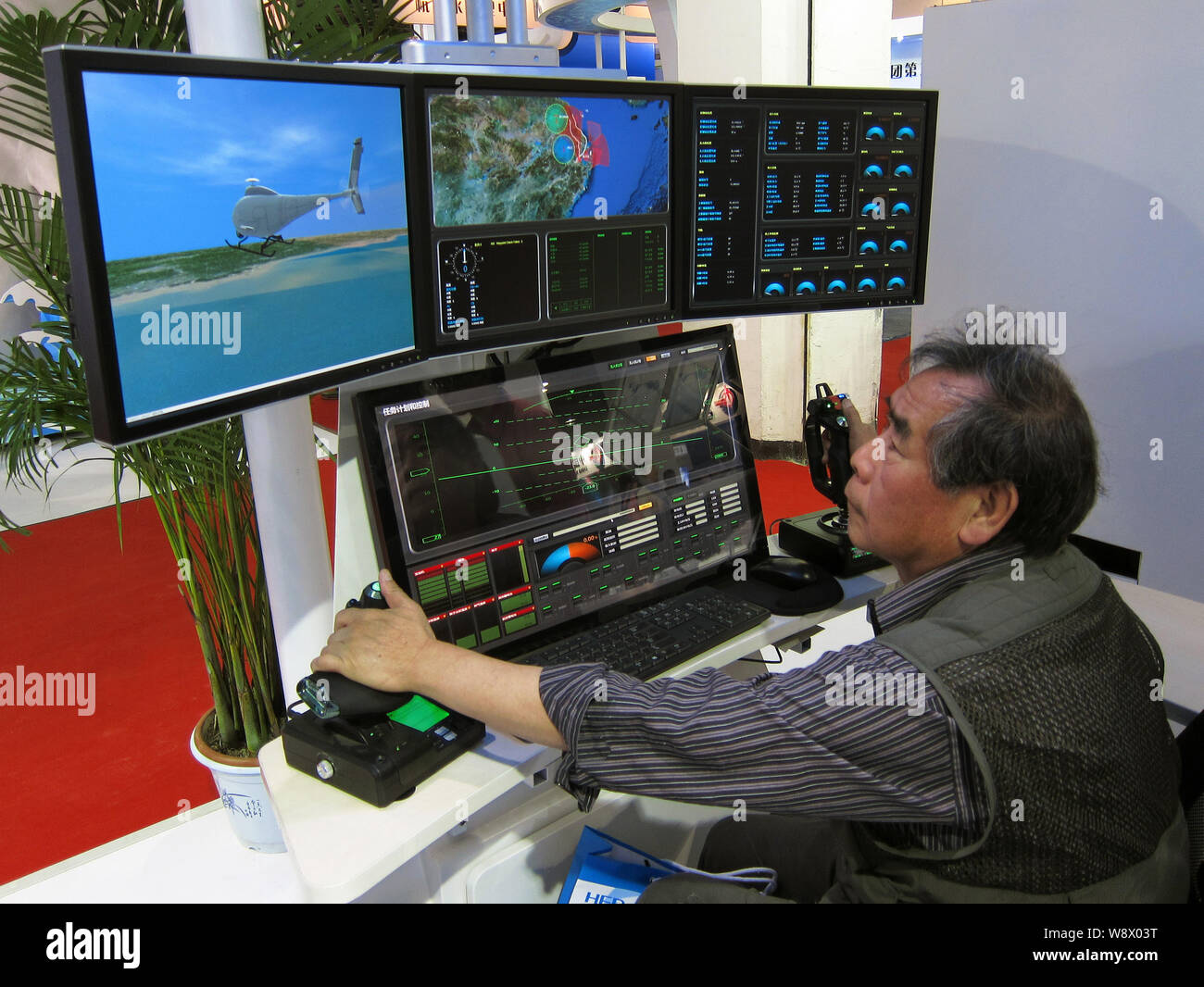 A visitor operates an unmanned multifunctional control station during the 17th China Beijing International High-Tech Expo (CHITEC) in Beijing, China, Stock Photo