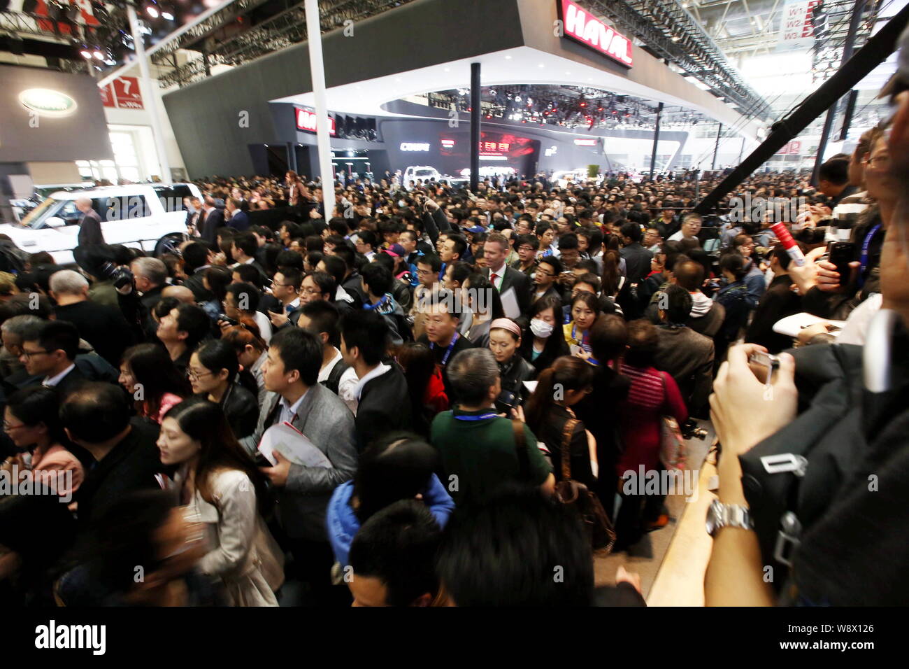 Visitors crowd the stands of Great Wall Motor and Land Rover during the ...