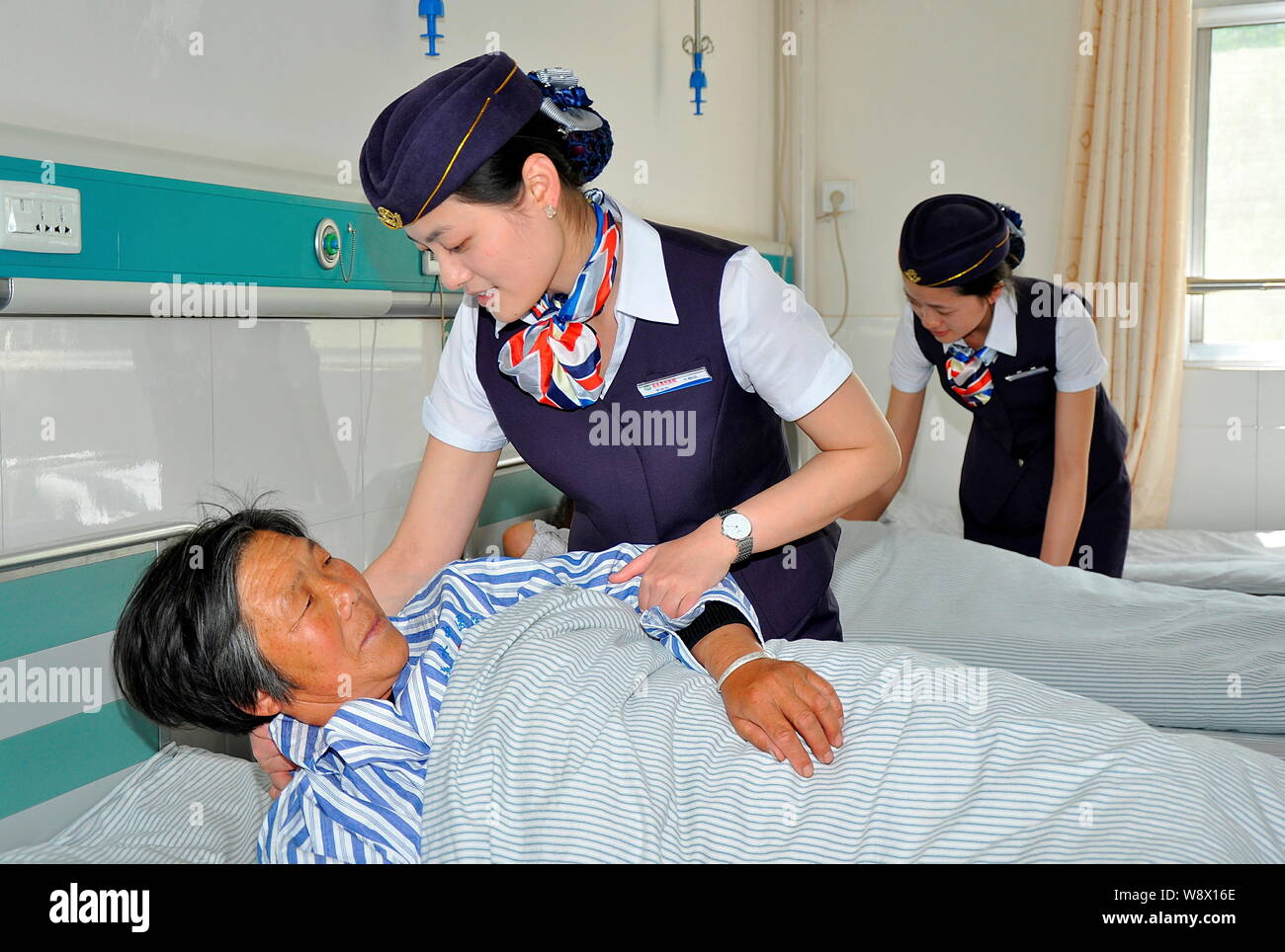 Chinese nurses dressed like flight attendants take care of patients at