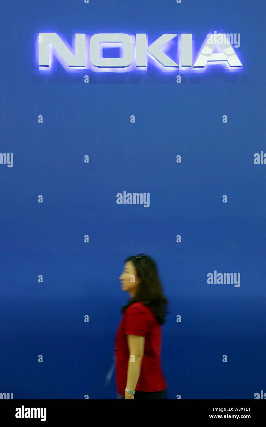 A visitor walks past the stand of Nokia during the 3rd Mobile Asia Expo (MAE) at the Shanghai New International Expo Center in Pudong, Shanghai, China Stock Photo
