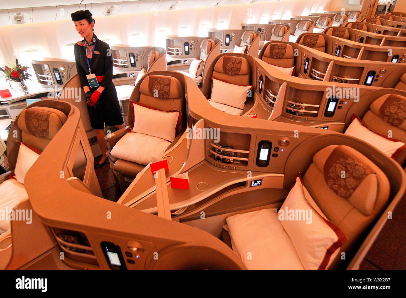 A Flight Attendant Poses In A Business Class Cabin Of A Boeing 777