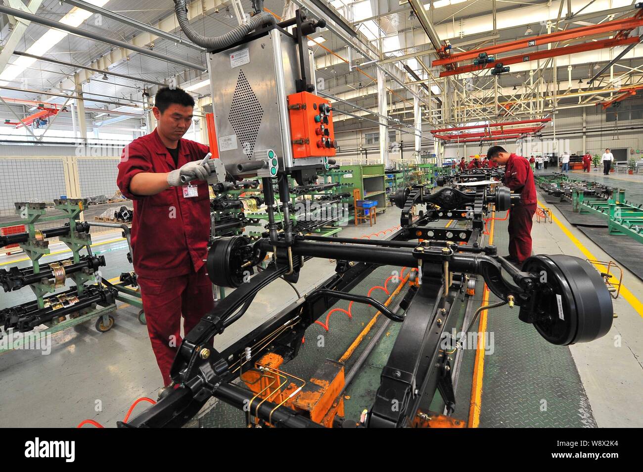 --FILE--Chinese workers assemble cars on the assembly line at an auto ...