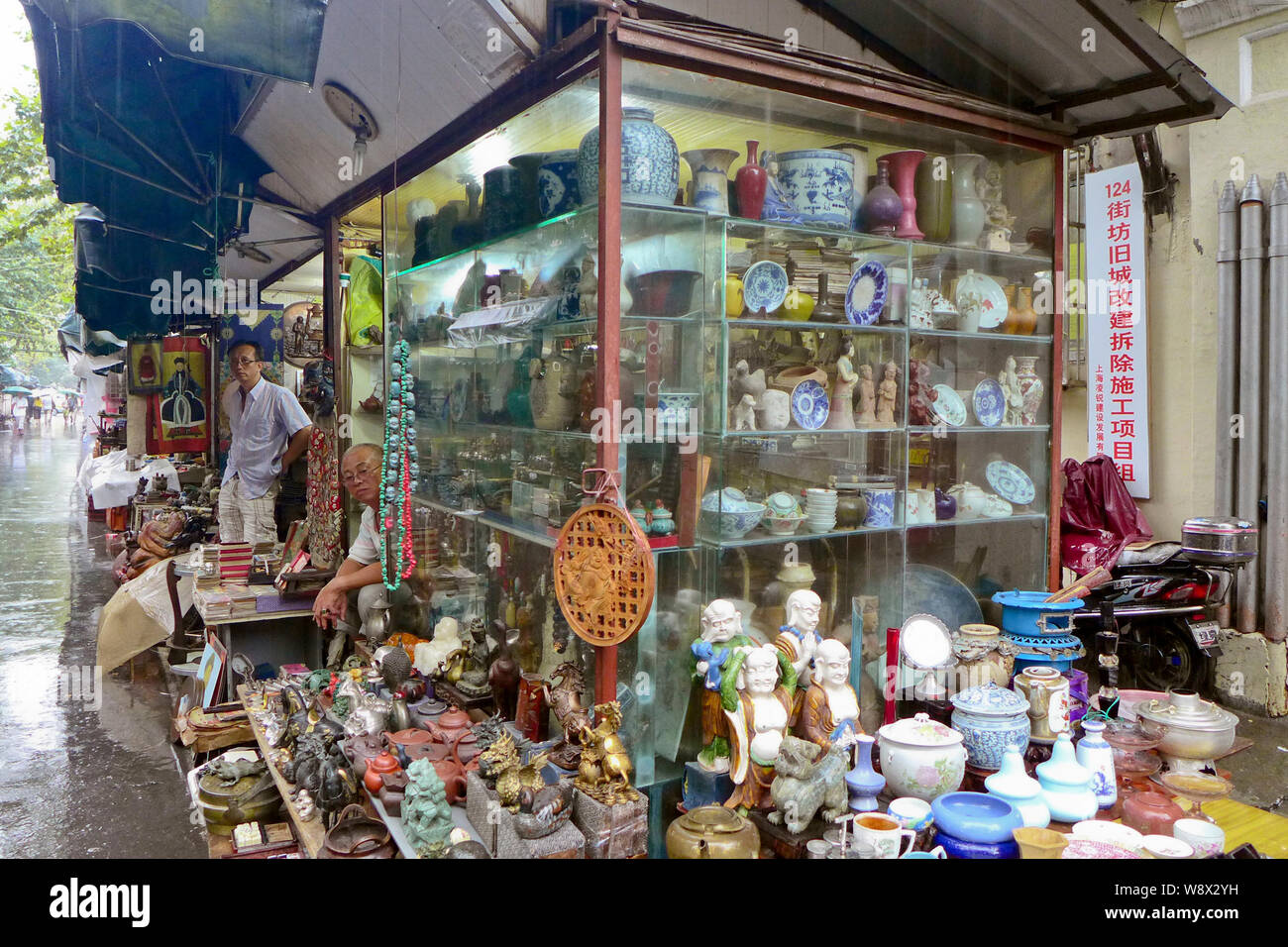Chinese vendors wait in their shops at the Shanghai Dongtai Road