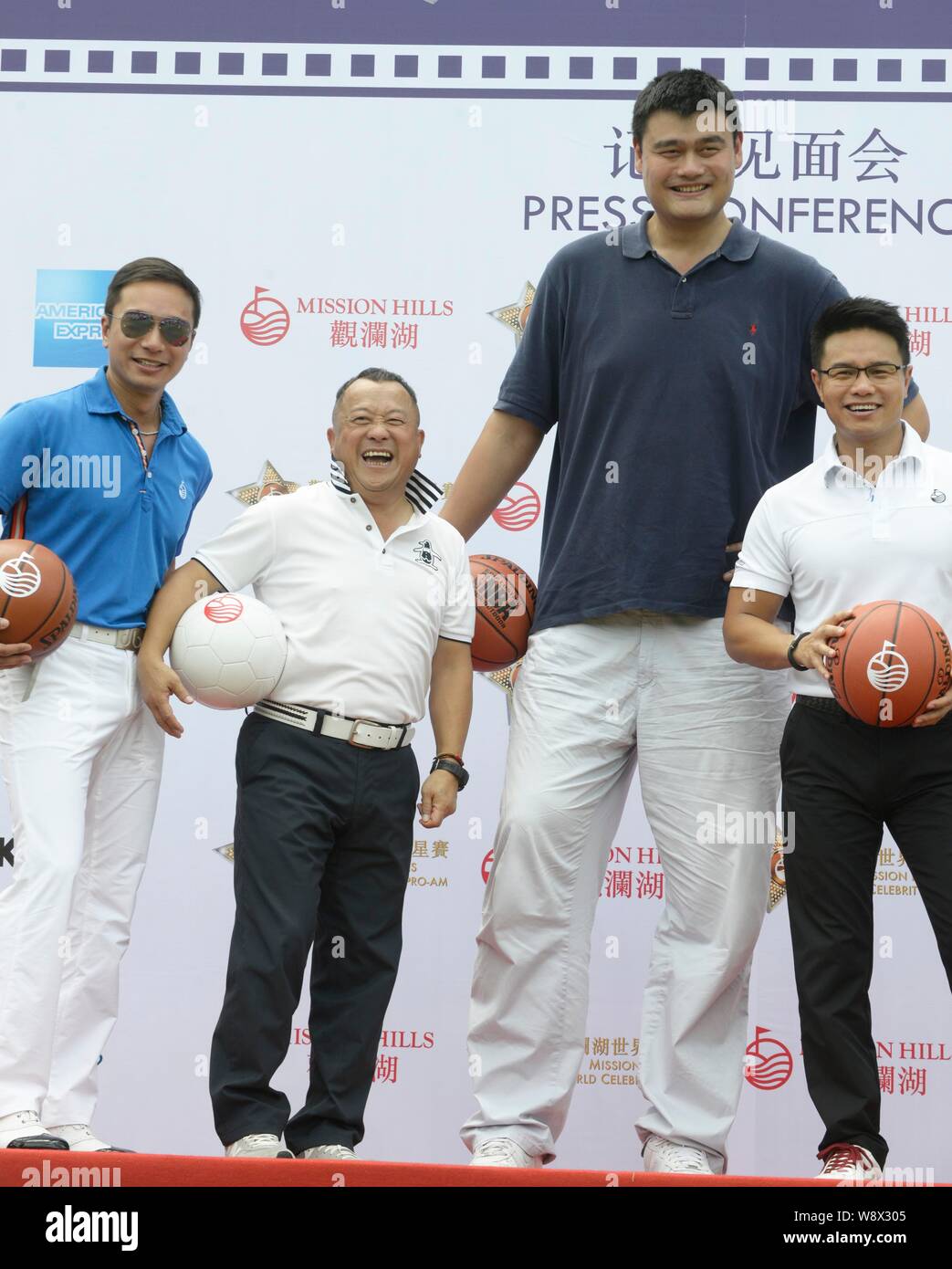 Retired Chinese basketball star Yao Ming, tallest, and Hong Kong actor Eric Tsang, second from left, attend a press conference for the 2014 Mission Hi Stock Photo