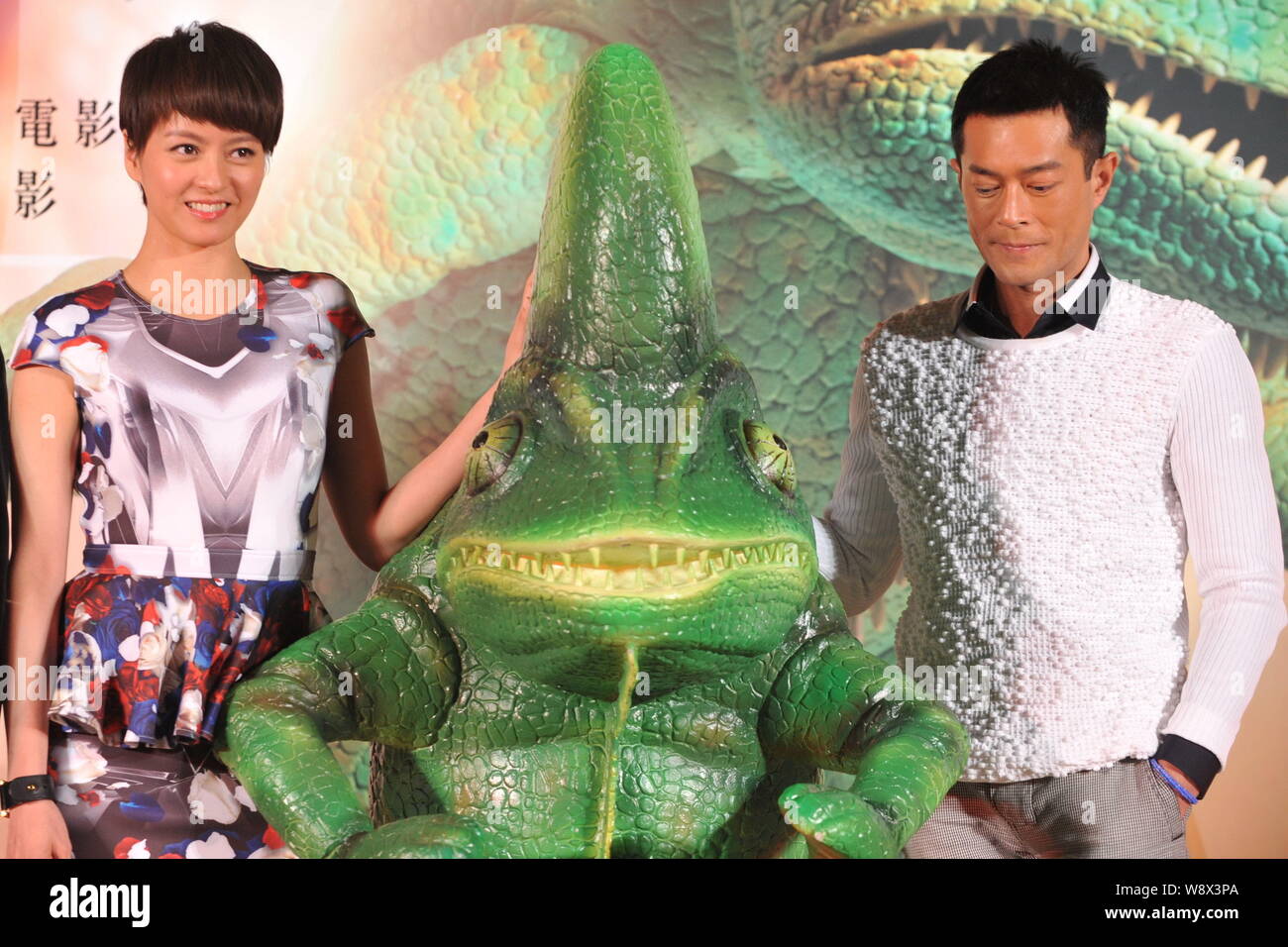 Hong Kong actress Gigi Leung, left, and Hong Kong actor Louis Koo pose with a toy chameleon during the premiere for their new film, Aberdeen, in Beiji Stock Photo