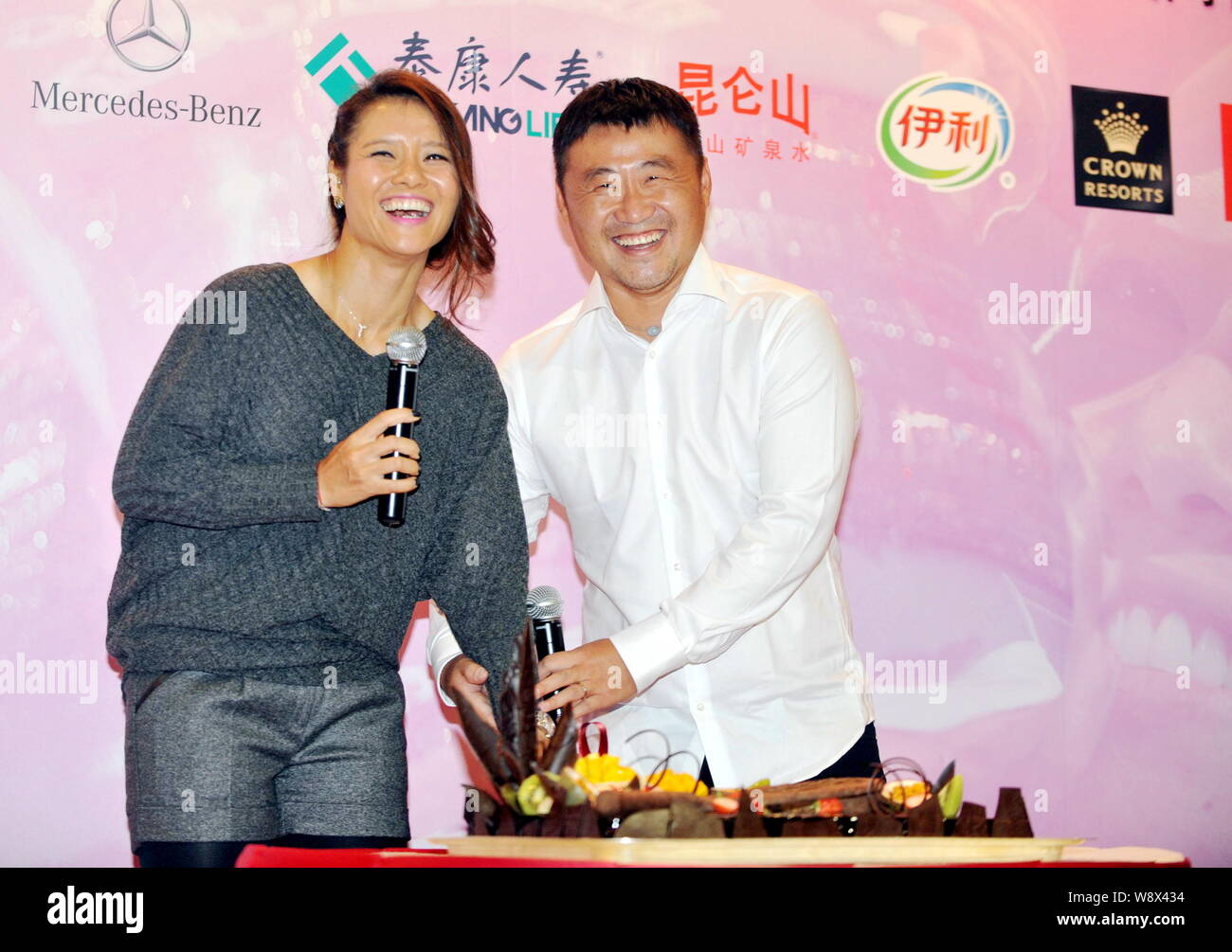 --FILE--Chinese tennis star Li Na, left, and her husband Jiang Shan laugh during a press conference for her new book in Beijing, China, 22 February 20 Stock Photo