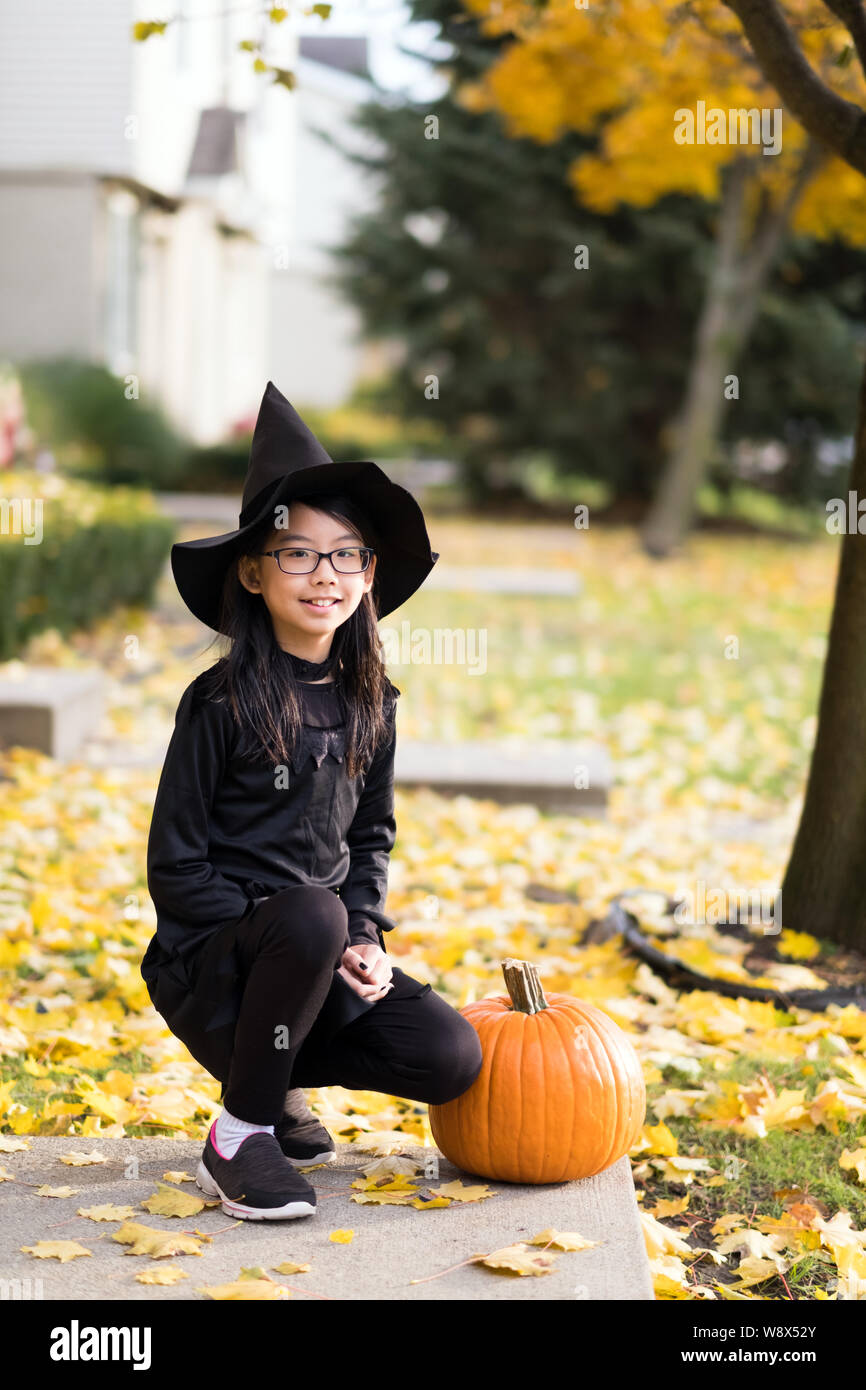 Portrait of little asian girl in witch costume Stock Photo