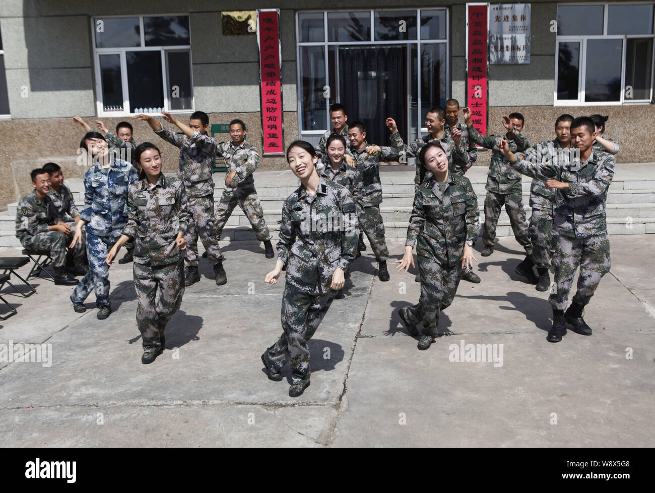 --FILE--Chinese PLA soldiers dance to the music of Little Apple at a military camp in Heihe city, northeast Chinas Heilongjiang province, 22 July 2014 Stock Photo