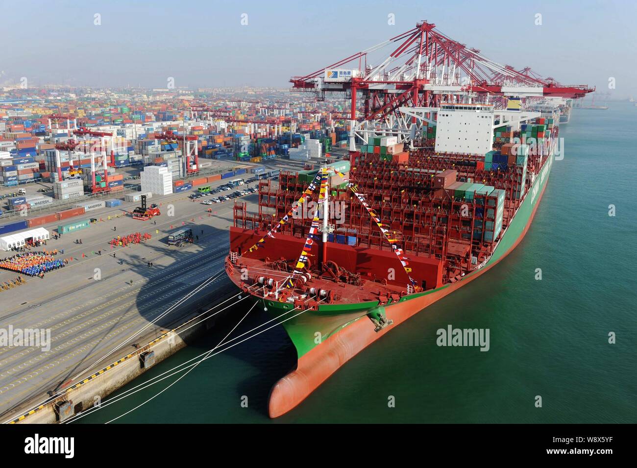 The world's largest container ship, CSCL (China Shipping Container Lines Co. Ltd) Globe, to be loaded with containers berths on a quay at the Port of Stock Photo