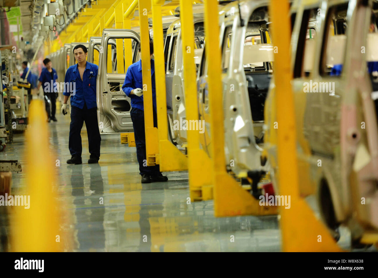--FILE--Chinese workers assemble cars on the assembly line at an auto ...