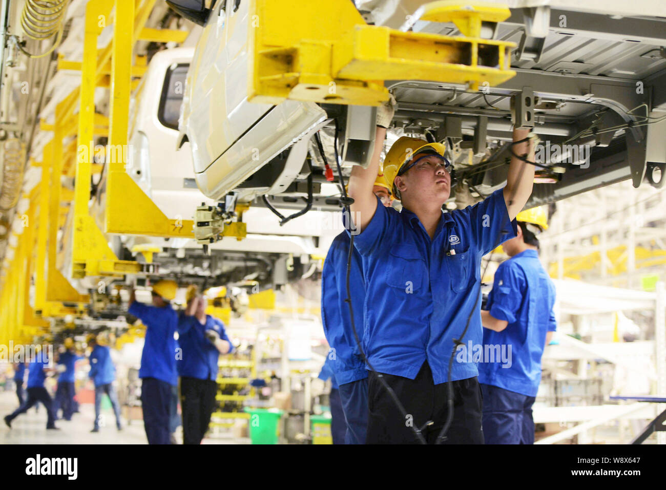 --FILE--Chinese workers assemble cars on the assembly line at an auto ...