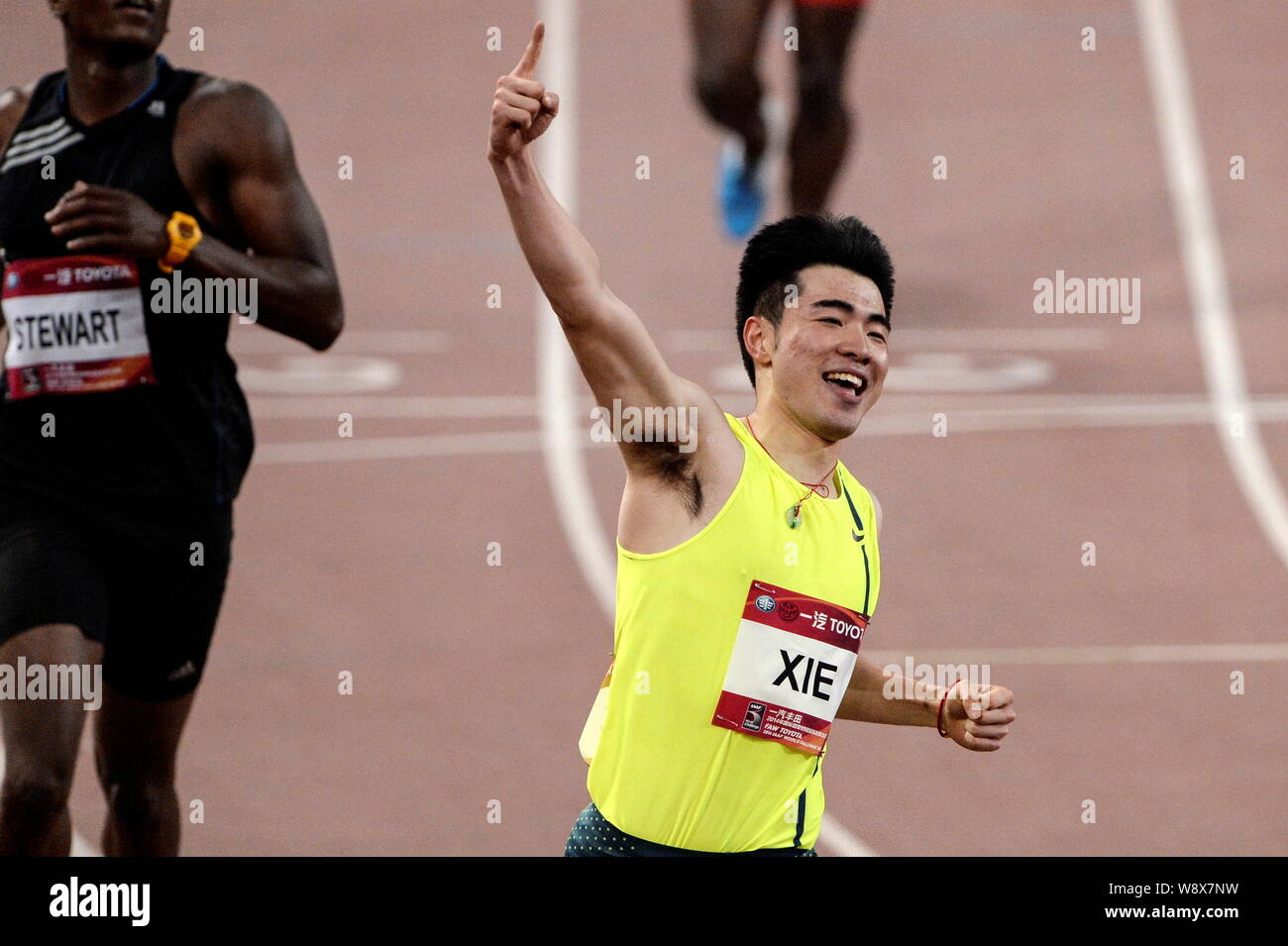 Xie Wenjun of China, front, celebrates after winning the mens 110m ...